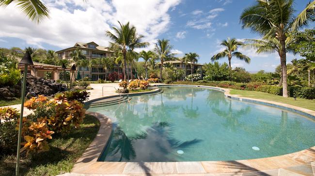 The pool is surrounded in privacy and tranquility with tropical landscaping