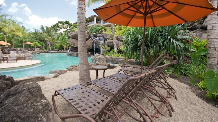 Enjoy island life under an umbrella poolside