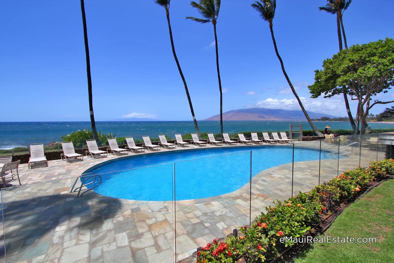 The pool area at Royal Mauian is surrounded by glass partitions to preserve the ocean views