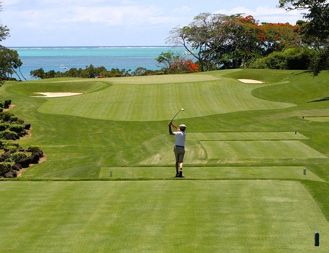 man golfing with view of the ocean