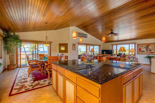 Kitchen and living room with wood slat ceiling