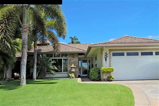 Home with green grass and palm tree