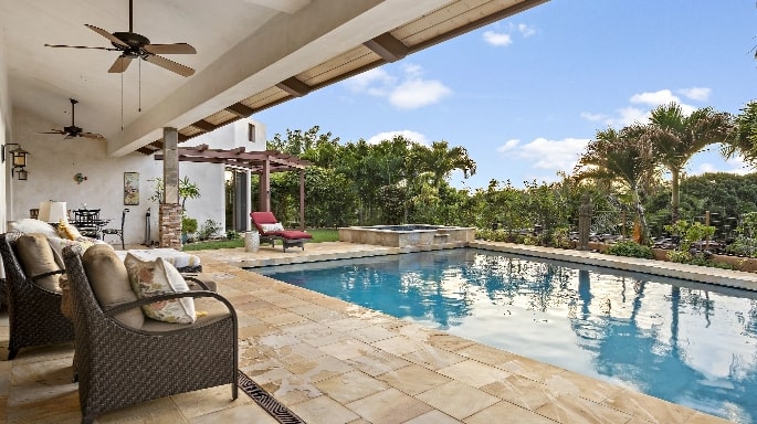 A home with a swimming pool backlit at night